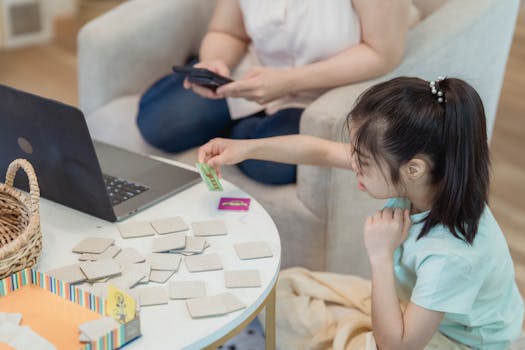 Asian girl focused on memory game at home with cards, enhancing cognitive skills.