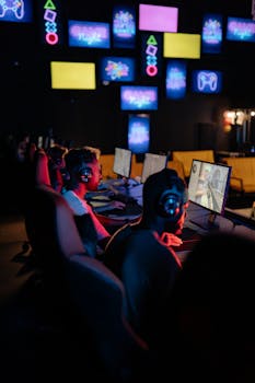 Competitive esports event with young adults gaming indoors. Focus on teamwork and technology.