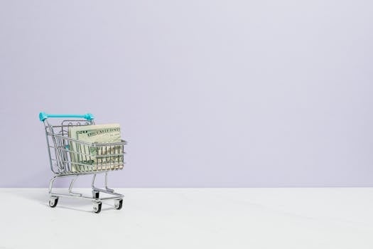 Shopping cart filled with cash on a plain background, ideal for finance and retail themes.